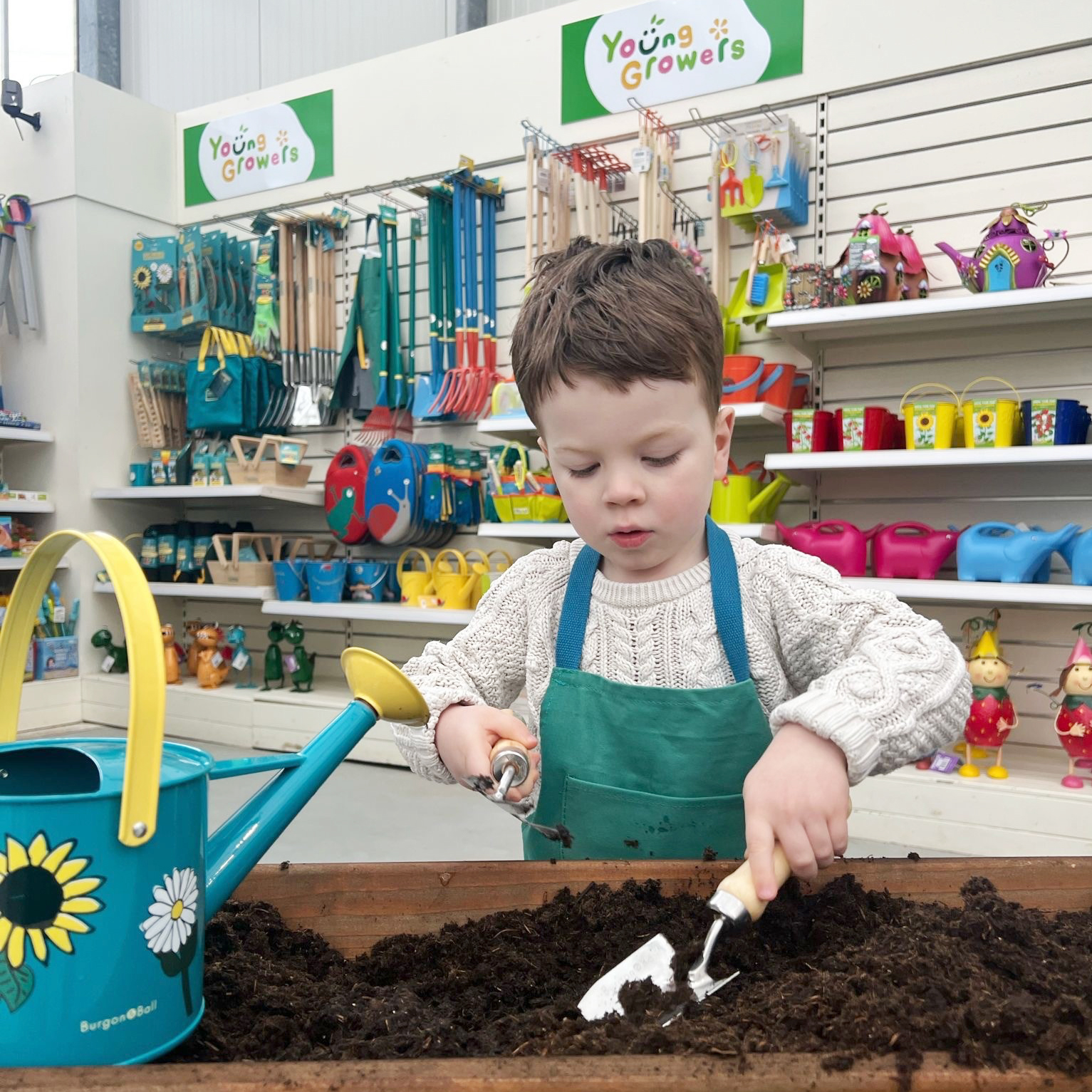 Photograph of child using the Young Growers gardening tools